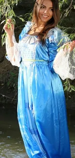 Woman in a blue dress amidst nature.