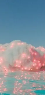 Dreamy cloud with pink lights over blue water.