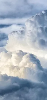 Fluffy cloudscape under a blue sky wallpaper.