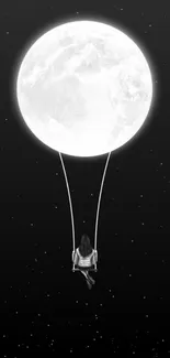 Silhouette on a swing beneath a large moon in a starry sky wallpaper.