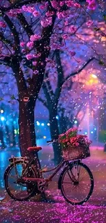 Bicycle under cherry blossoms at night on a serene street.