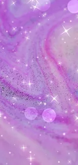 Abstract pink and purple galaxy swirl wallpaper with sparkles.