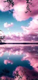 Pink clouds reflect on a serene lake under a blue sky.