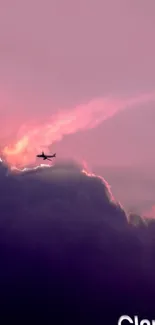 An airplane silhouette against purple-pink clouds with a dreamy sky backdrop.