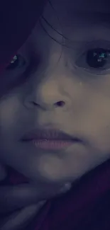 Child's face in soft, purple-tinted close-up.