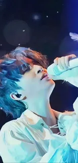 Singer in white attire and blue light performing passionately.