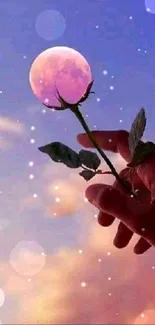 Hand holding a rose against a dreamy purple sunset sky.