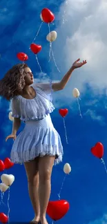 Woman in white dress reaching for balloons in a blue sky.