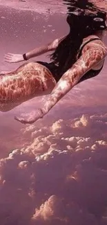 Surreal pink cloud wallpaper with swimmer.