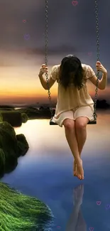 Person on swing over reflective water at dusk with mossy rocks.