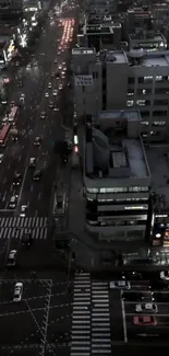 Aerial view of a city street bustling with traffic at dusk.