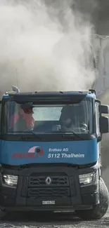 Truck in motion with dust cloud in background.