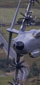 Aerial view of an aircraft flying over green fields.