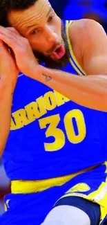 Basketball player in blue and yellow jersey in action on vibrant wallpaper.