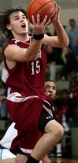 Basketball player mid-air in dynamic action shot.