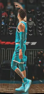 Action shot of a basketball player in a teal jersey taking a dynamic shot on the court.