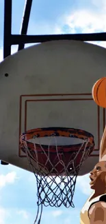 Basketball player dunks ball against blue sky.