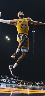 Basketball player dunking in yellow jersey on court.