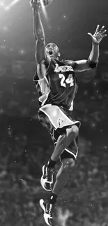 Monochrome image of a basketball player leaping mid-air.