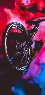 Vibrant action scene of a cyclist in motion with red and blue smoke.