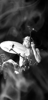 Black and white drummer on stage, caught in a dynamic moment.