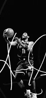 Black and white image of a basketball player performing a slam dunk.