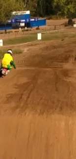 BMX racer speeding on a dirt track with vibrant gear.