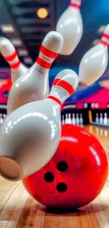 A vibrant bowling strike action with pins and a red ball on a wooden lane.