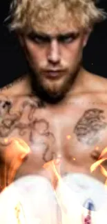 Portrait of a tattooed boxer with fiery elements on a black background.