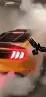 Orange car performing burnout with smoke and black bird design.