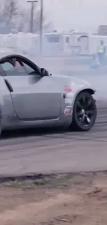 Car drifting with smoke on a track.