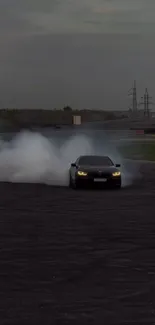 Car drifting through smoke at night on a track.