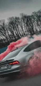 Sleek car moving through pink smoke on a cloudy road.