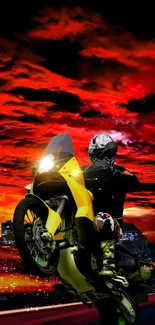 Motorcycle performing a wheelie at night with a vibrant red sky backdrop.