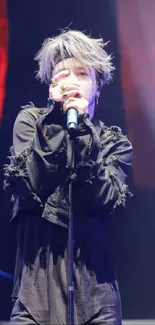 Energetic stage performance with vivid lighting and singer in black outfit.