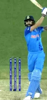 Cricketer hitting shot in blue jersey on green field.