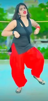 Colorful dance pose with red and black outfit