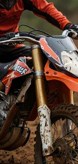 Dirt bike racing through muddy track.