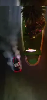 Car drifting around a city street corner at night with lights.