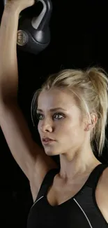 Woman lifting kettlebell in fitness pose.