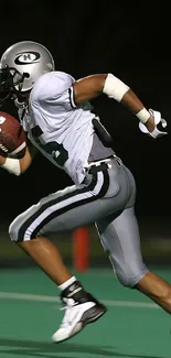 Football player in action on the field, running swiftly.