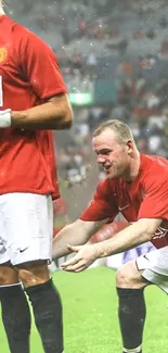 Soccer players in red jerseys during a match, capturing a dynamic moment on the field.