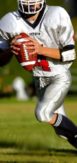 Football player in action on the field, wearing a white and red uniform.