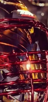 Red and gold football helmet with dynamic reflections.