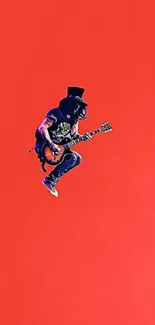 Guitarist jumping on a vibrant red background wallpaper.