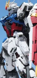 Gundam robot in dynamic pose against blue sky.