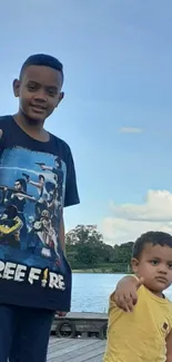 Two kids enjoying a sunny day by the lake.