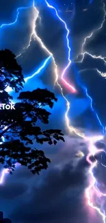 Vivid lightning storm with glowing night sky and silhouette of tree.