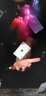 Magical display of falling cards and colorful smoke on a black background.