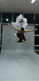 Martial artist leaps dynamically in studio.